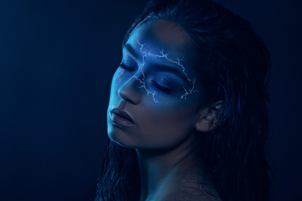 Cinematic beauty portrait of a woman with wet hair and blue lighting by Art by Light Photography.